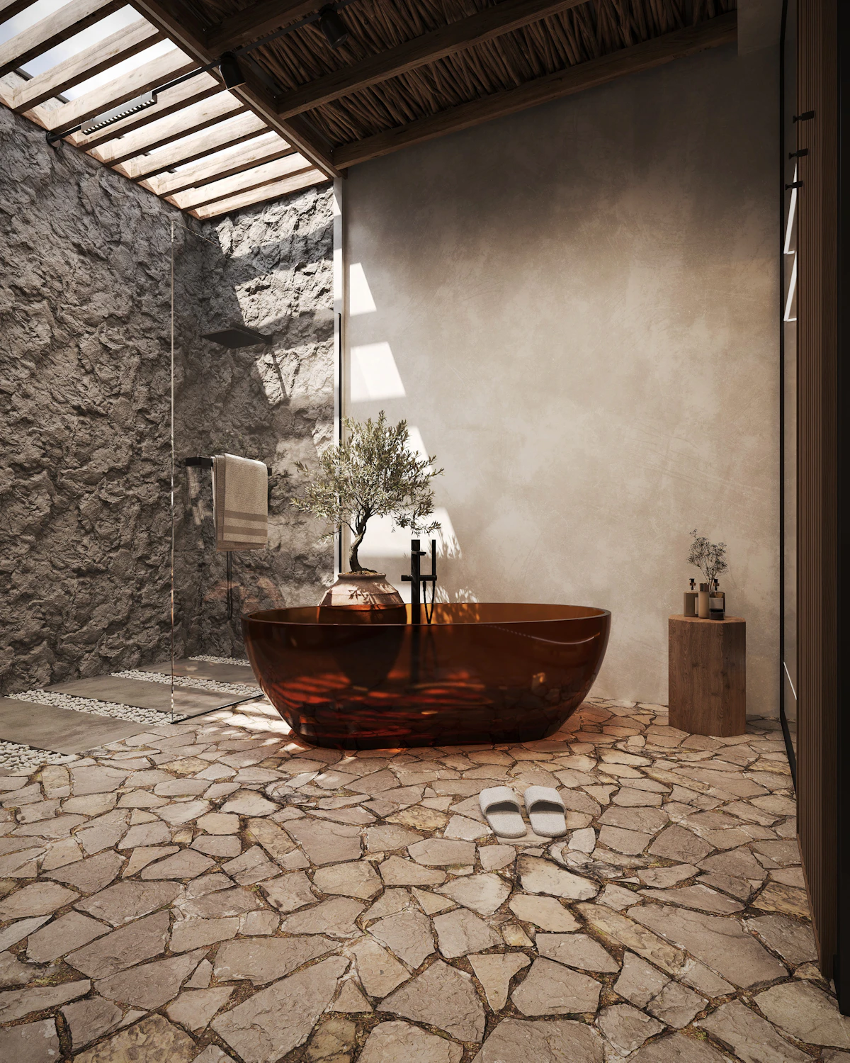 An outdoor bathroom with a terrazzo basin and aged brass fixtures under a frangipani tree.